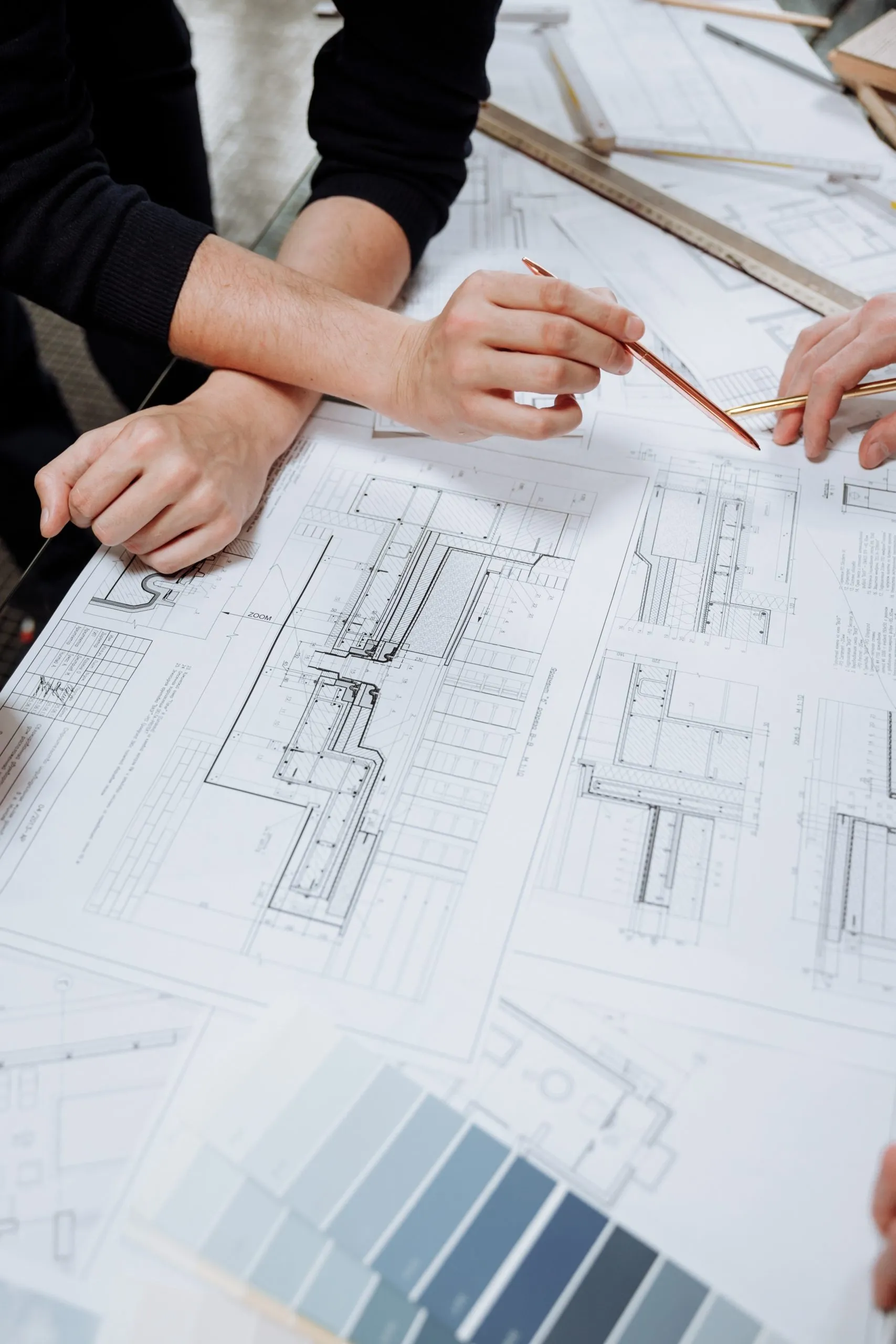 Architects reviewing construction detail drawings